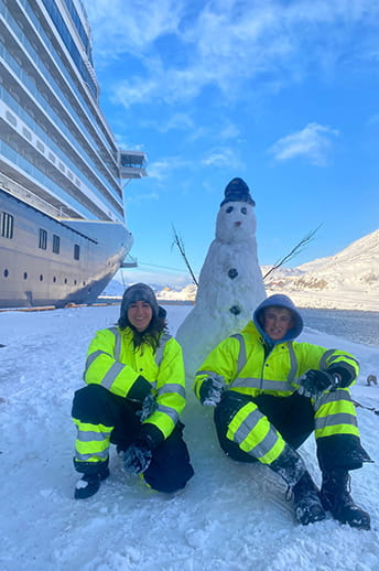 Deck cadets Elena and Harry building a snowman on the pier